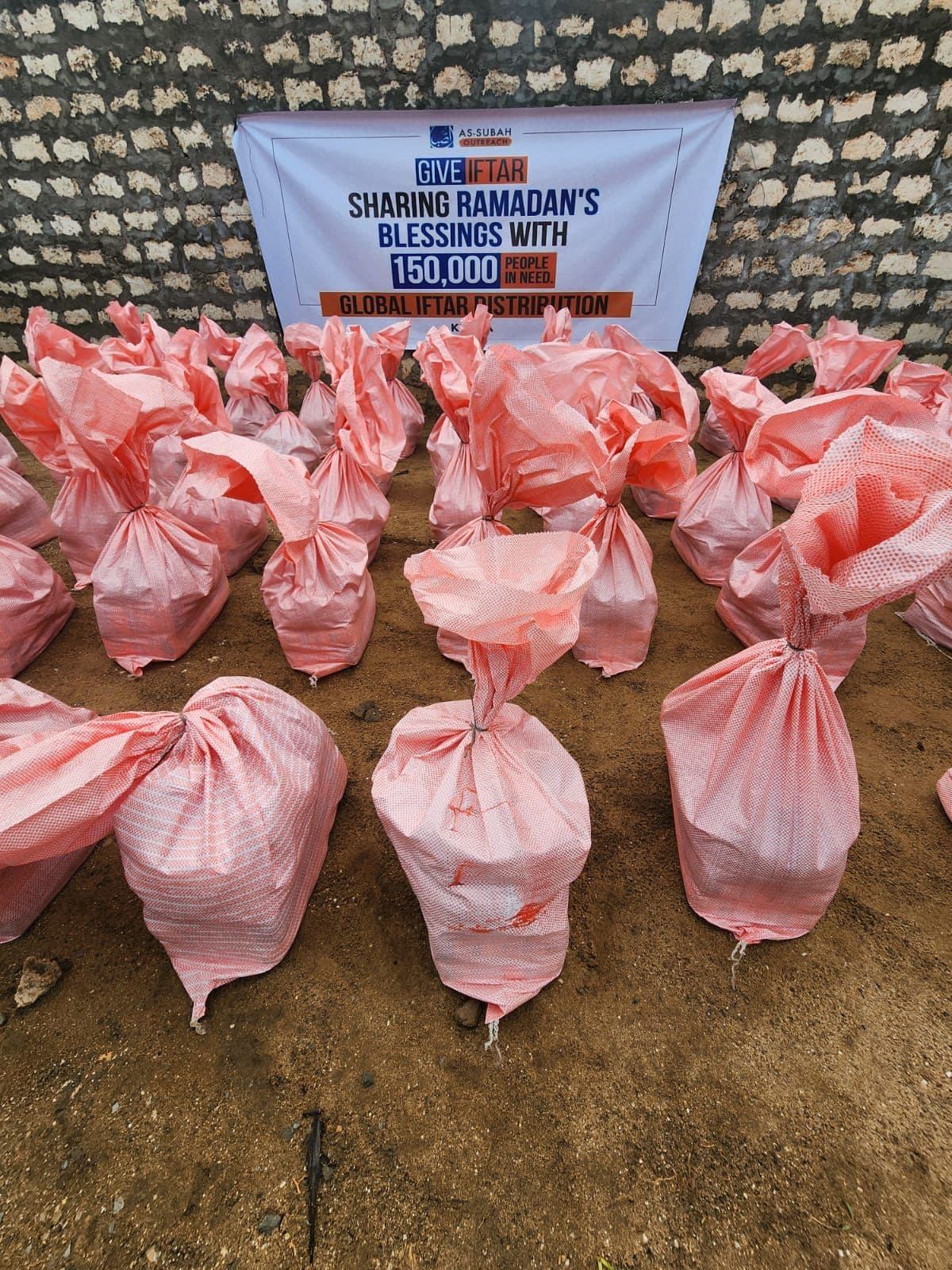 Volunteers packing donation boxes with supplies
